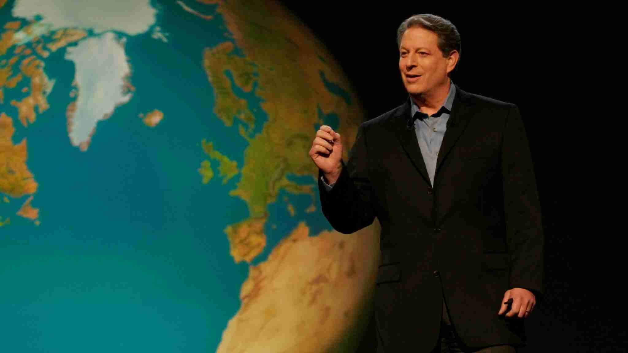 1. Man giving a presentation with a world map in the background, focusing on geography and education.