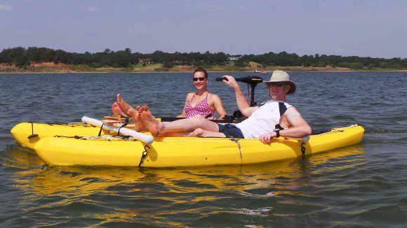 Side profile of the homemade PVC-frame kayak catamaran (CatamaYak) floating on the lake.