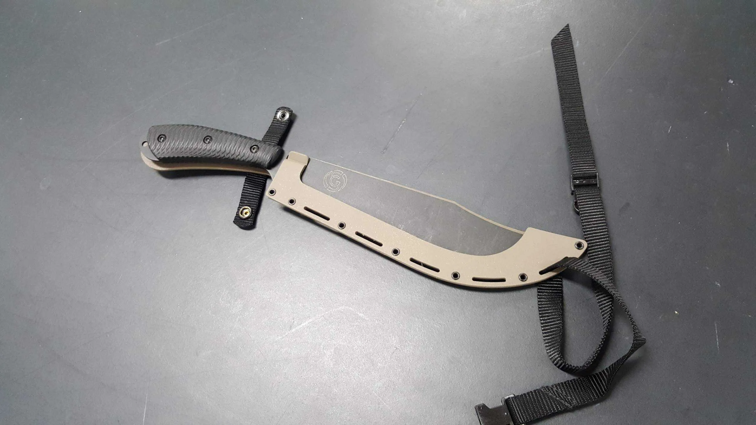 Southern Grind Grandaddy G2 fixed blade machete with brown Kydex sheath for camping and survival.